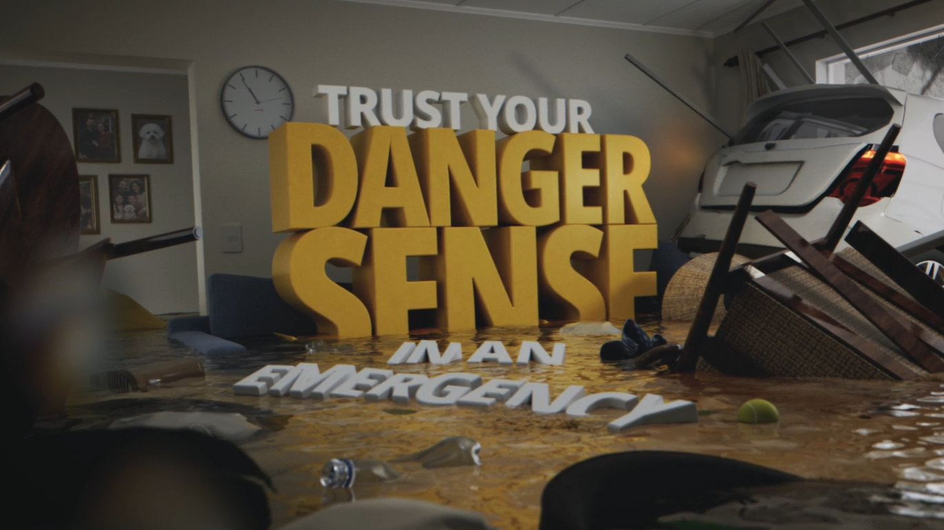 The aftermath of a severe flood in a living room, with the words &quot;Trust your danger sense in an emergency&quot; floating amongst the debris
